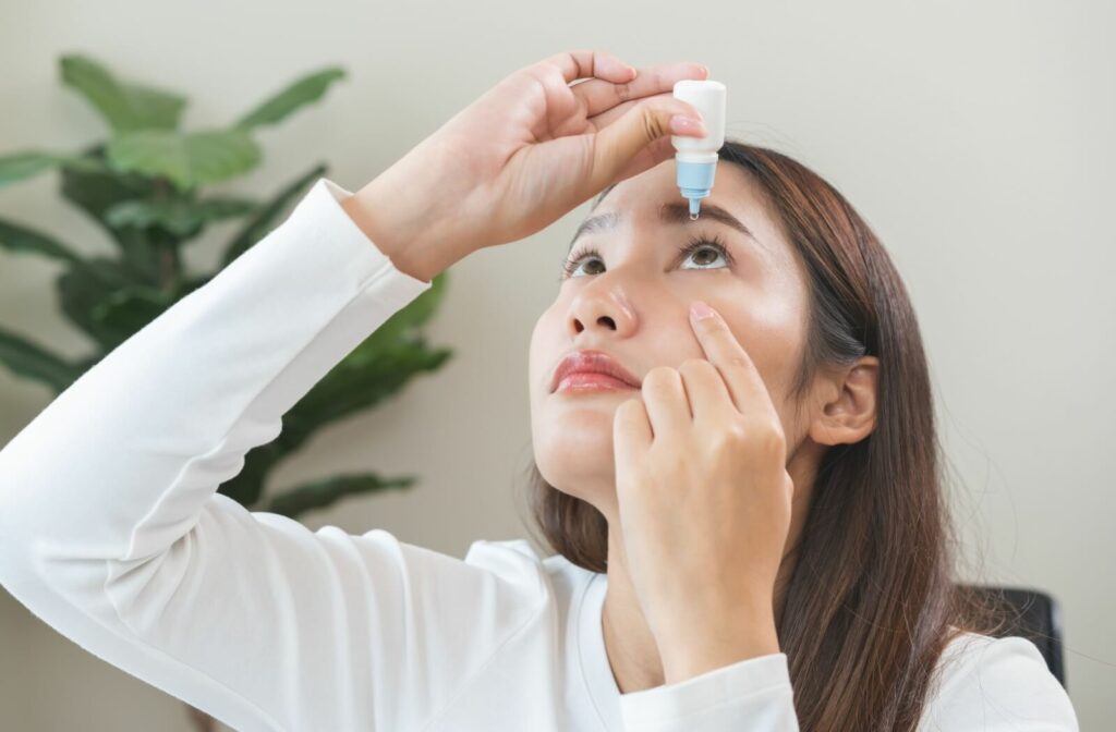 young woman applying, using medical eye drops to treat dry eye 