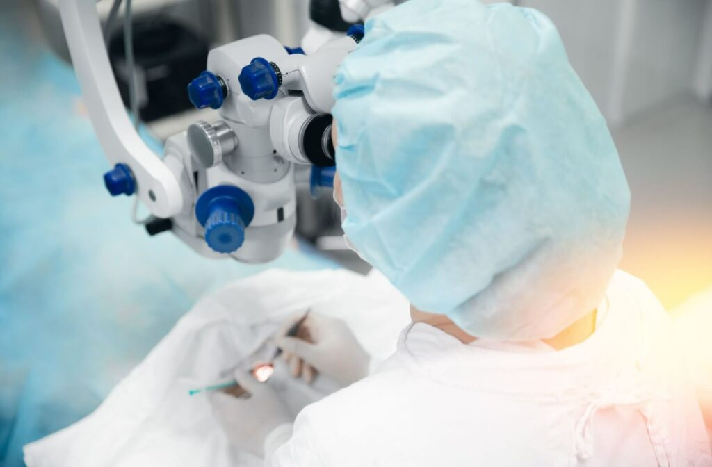 Surgeon uses high-precision laser microscope while performing eye surgery on a patient in a sterile environment