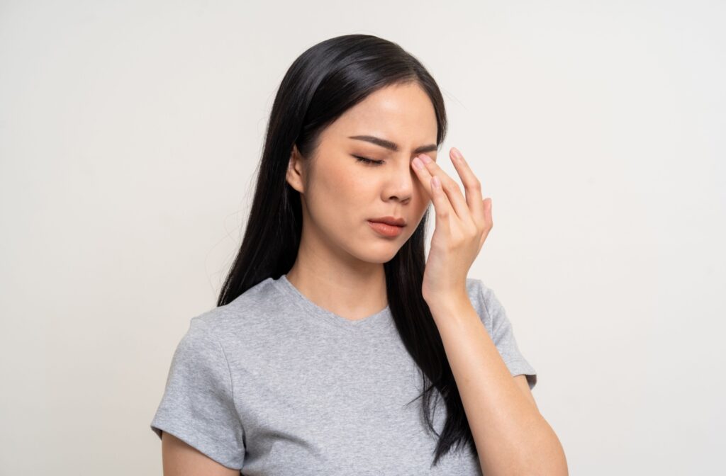 A person rubs their irritated eye to sooth their eye discomfort